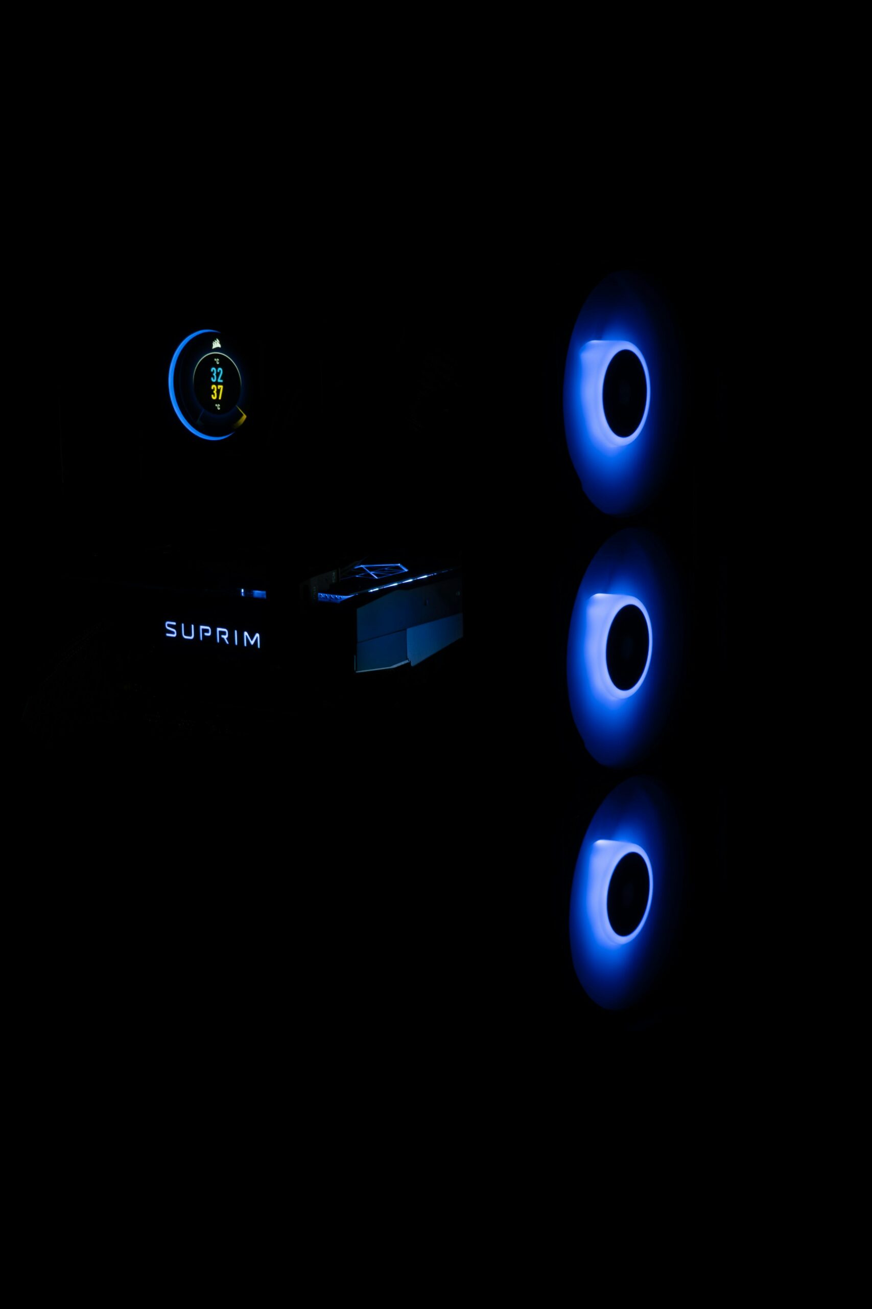 a dark room with three blue lights on the wall