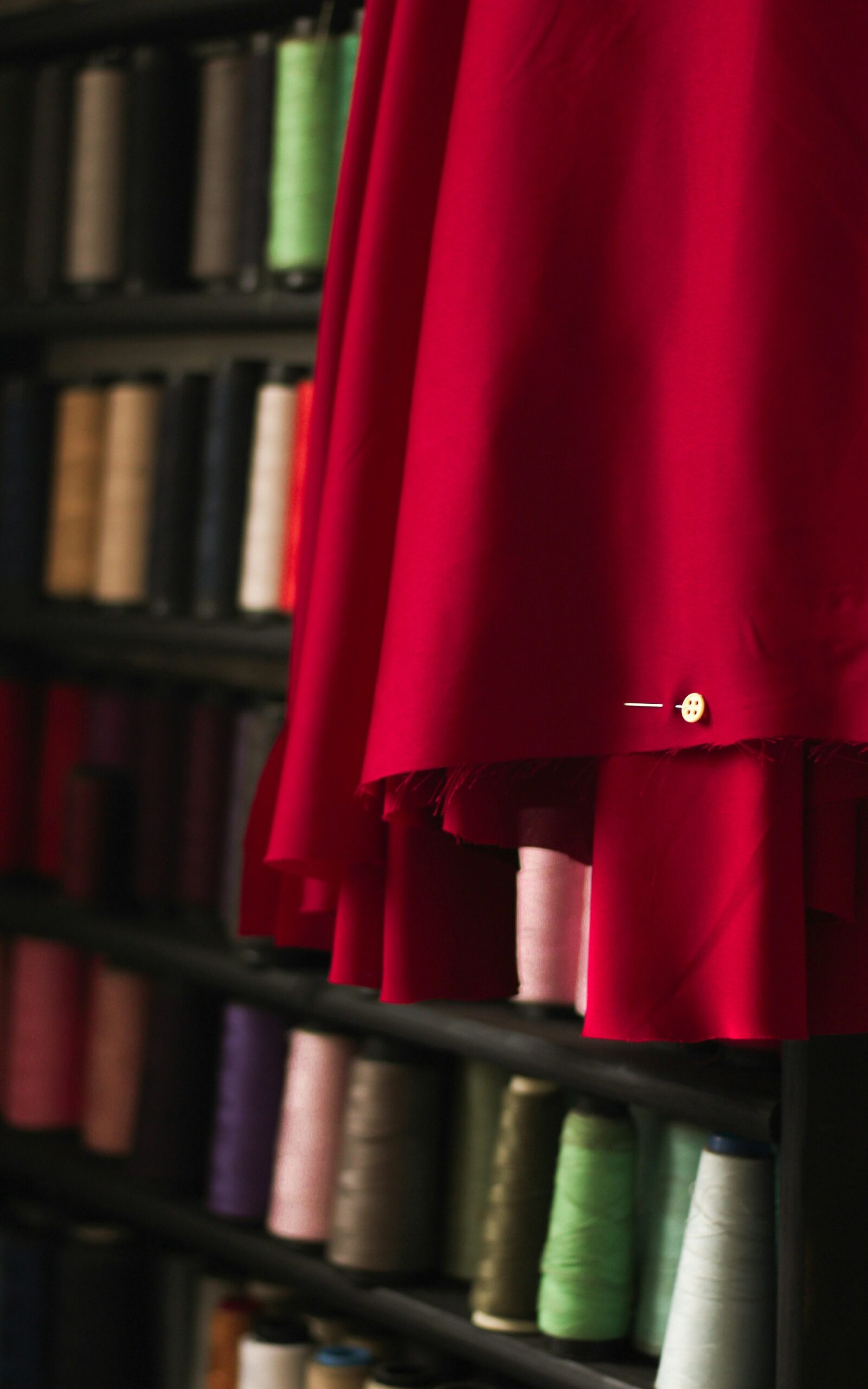 a rack of different colored spools of thread