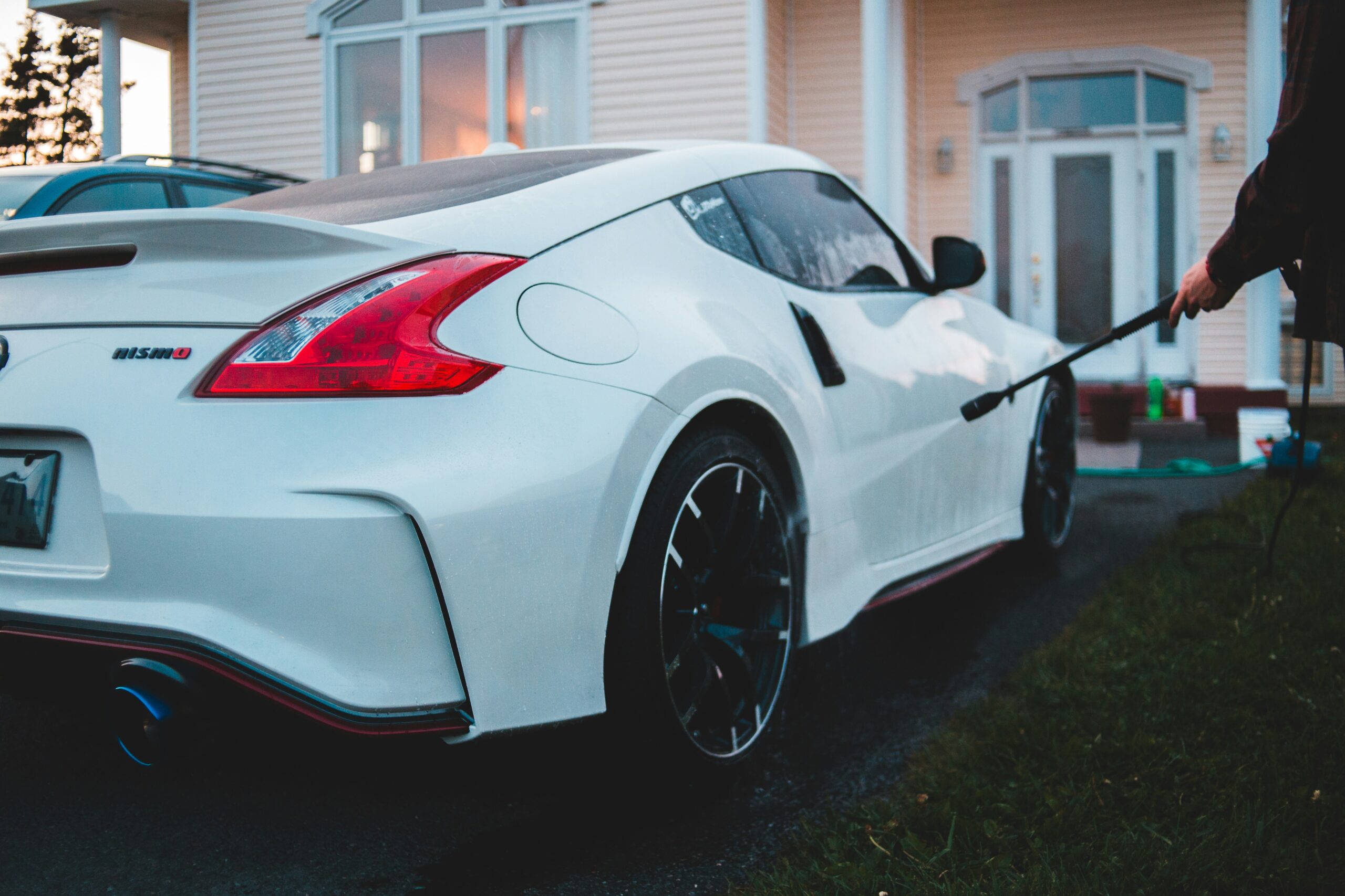 white porsche 911 parked near white house